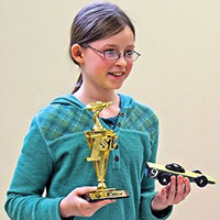 Girl awana racer with car and trophy