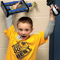 cub scout grand champion with trophy and car